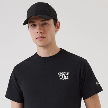 The model is wearing this New Era Script Graphic T-Shirt in black. 5