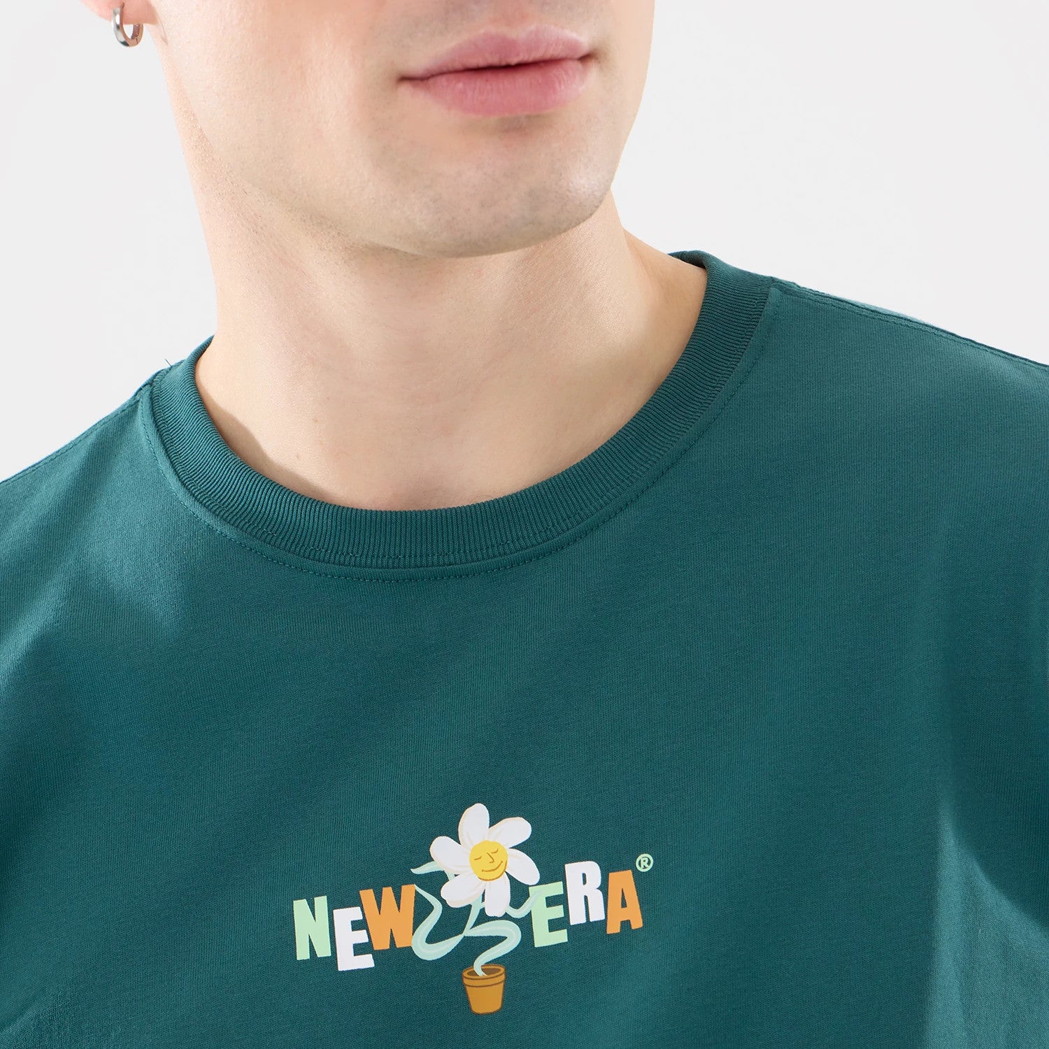 The model is wearing this New Era Earth Day T-Shirt in dark green. 3