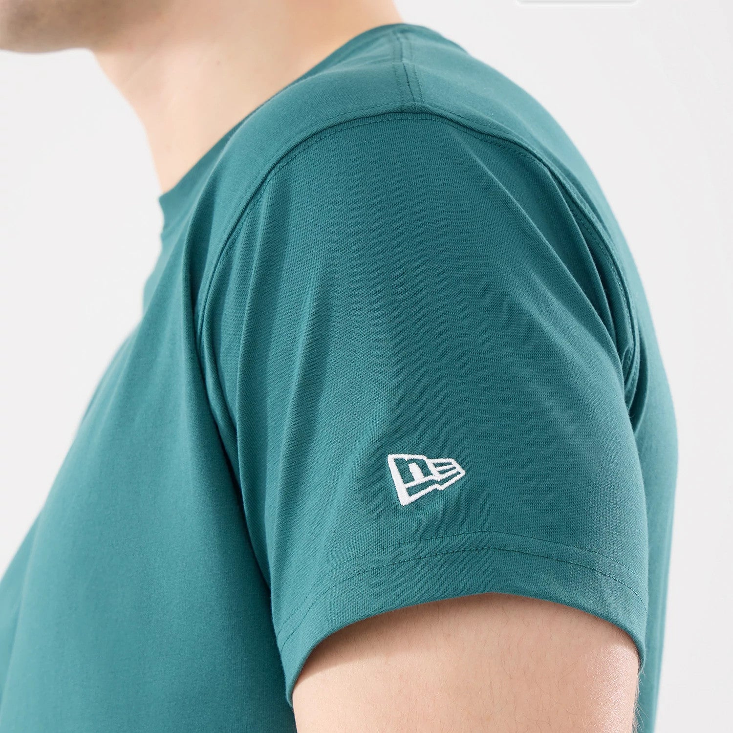 The model is wearing this New Era Earth Day T-Shirt in dark green. 4