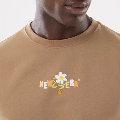 The model is wearing this New Era Earth Day T-Shirt in beige/khaki. 3