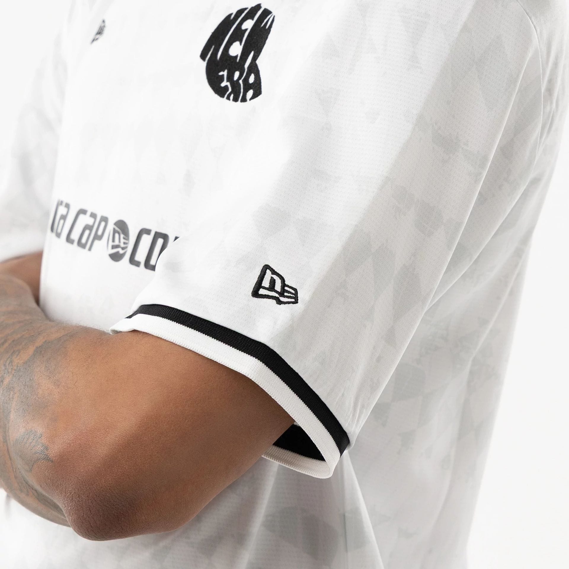 The model is wearing this New Era Soccer Jersey in white. 5