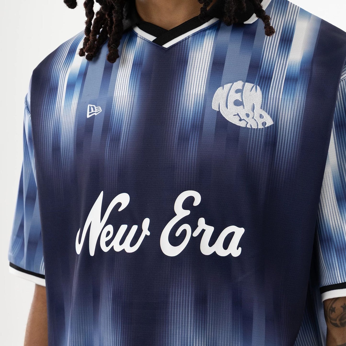 The model is wearing this New Era Soccer Jersey in navy. 5