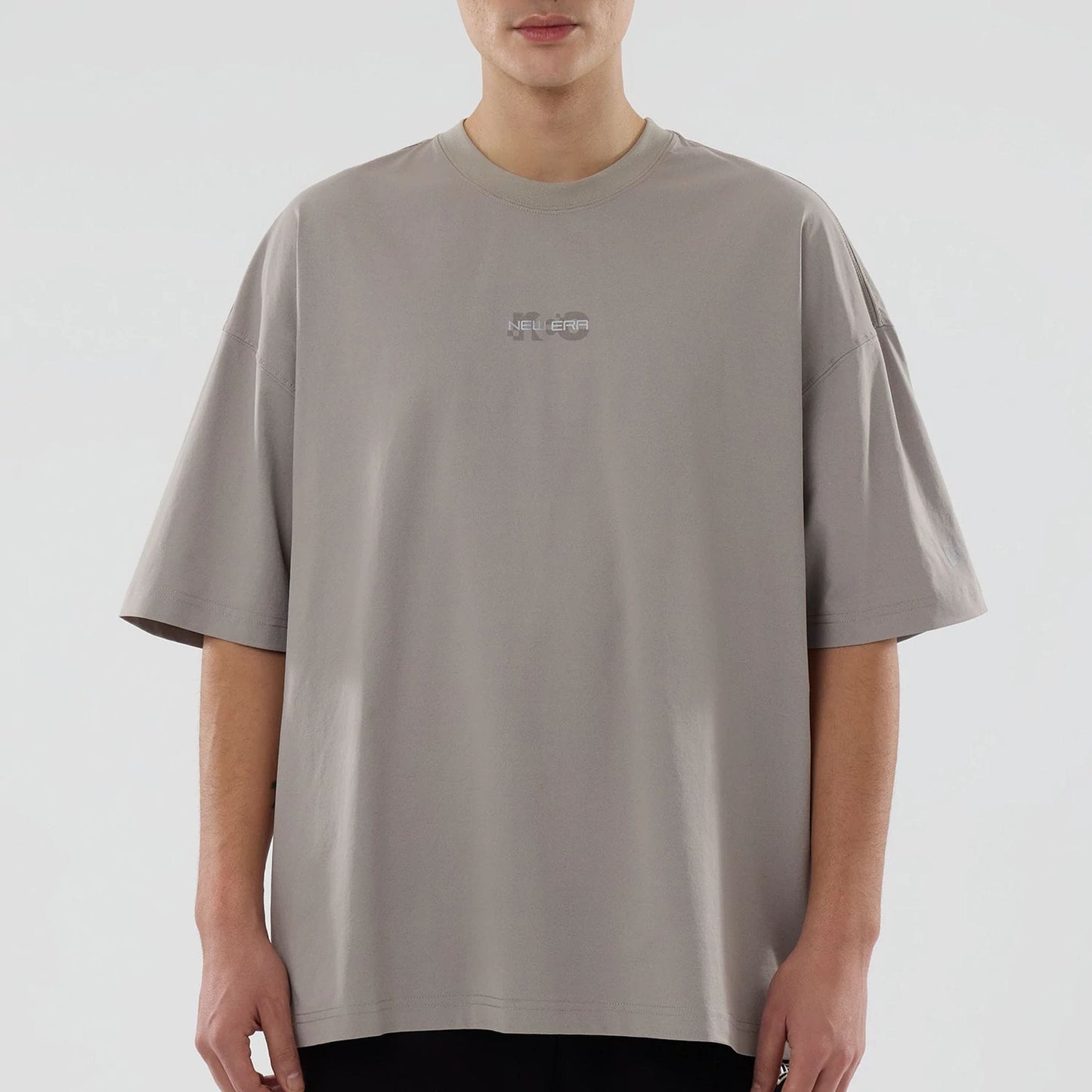 The model is wearing this New Era NEC Logo Oversized T-Shirt in Beige. 5