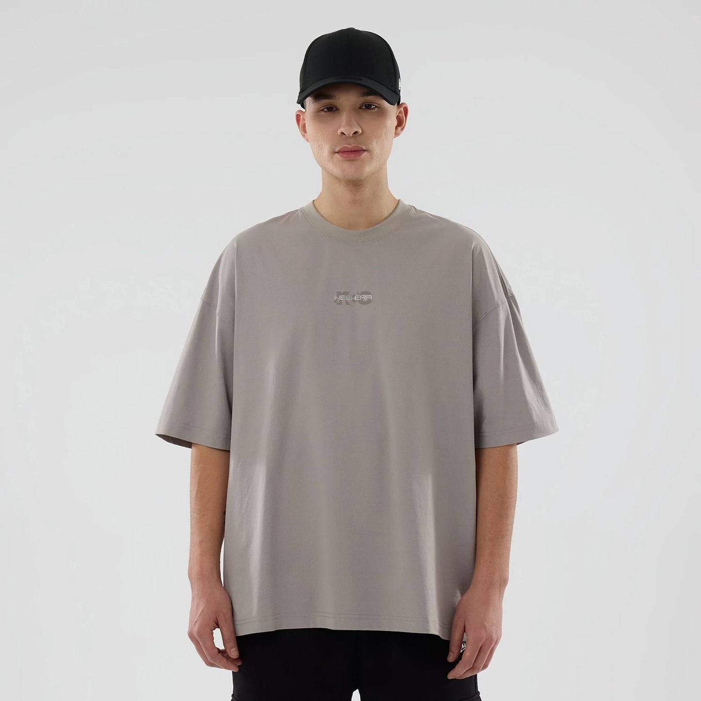 The model is wearing this New Era NEC Logo Oversized T-Shirt in Beige. 1