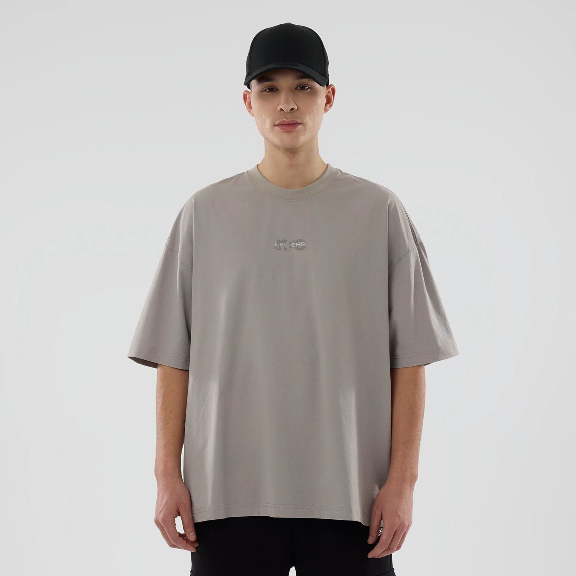 The model is wearing this New Era NEC Logo Oversized T-Shirt in Beige. 1