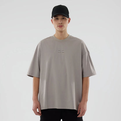 The model is wearing this New Era NEC Logo Oversized T-Shirt in Beige. 1