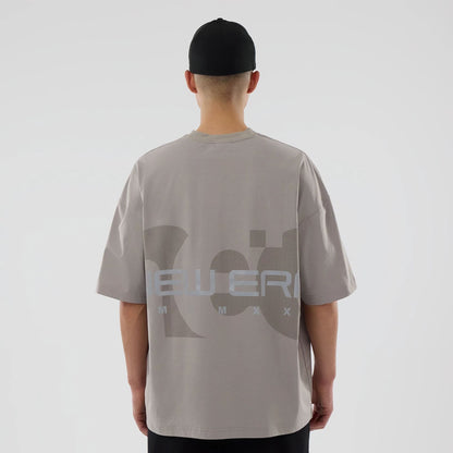 The model is wearing this New Era NEC Logo Oversized T-Shirt in Beige. 2