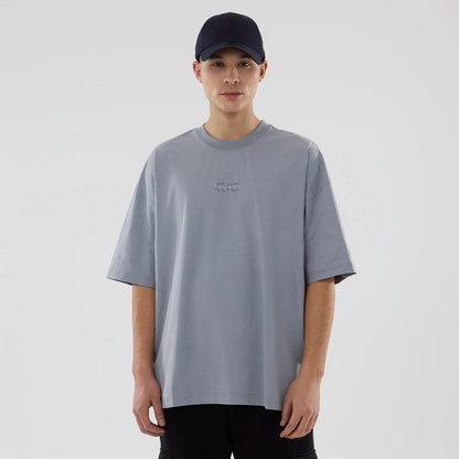 The model is wearing this New Era NEC Logo Oversized T-Shirt in grey. 1