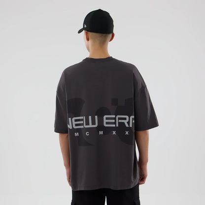 The model is wearing this New Era NEC Logo Oversized T-Shirt in black. 2