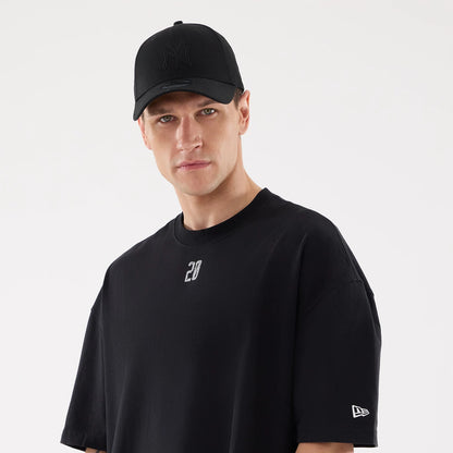 The model is wearing this New Era Street Archived City Oversized T-Shirt in black. 6
