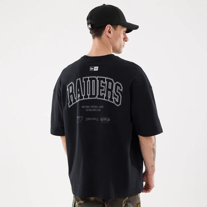The model is wearing this NFL Raiders Wear Las Vegas Raiders Oversized T-Shirt in black. 2