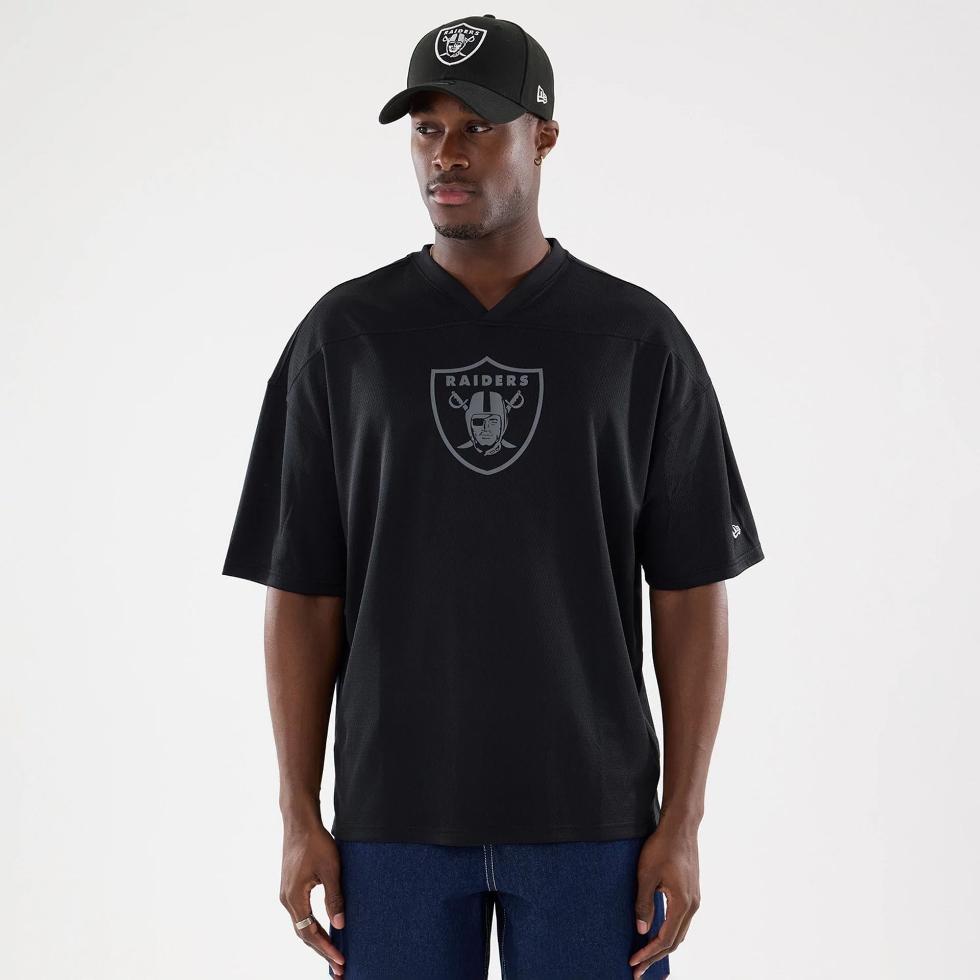 The model is wearing this NFL Raiders Wear Black Las Vegas Raiders Mesh Oversized T-Shirt in black. 1