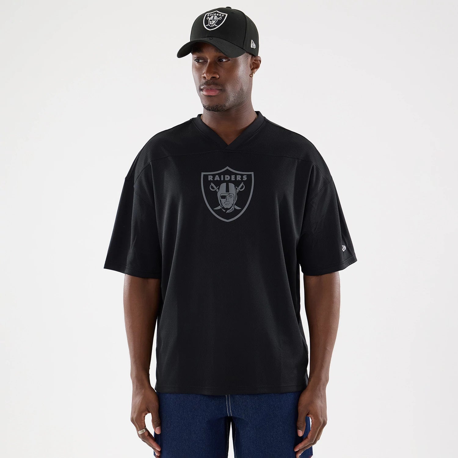 The model is wearing this NFL Raiders Wear Black Las Vegas Raiders Mesh Oversized T-Shirt in black. 1