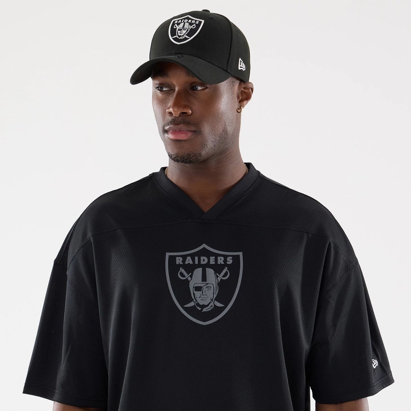 The model is wearing this NFL Raiders Wear Black Las Vegas Raiders Mesh Oversized T-Shirt in black. 6