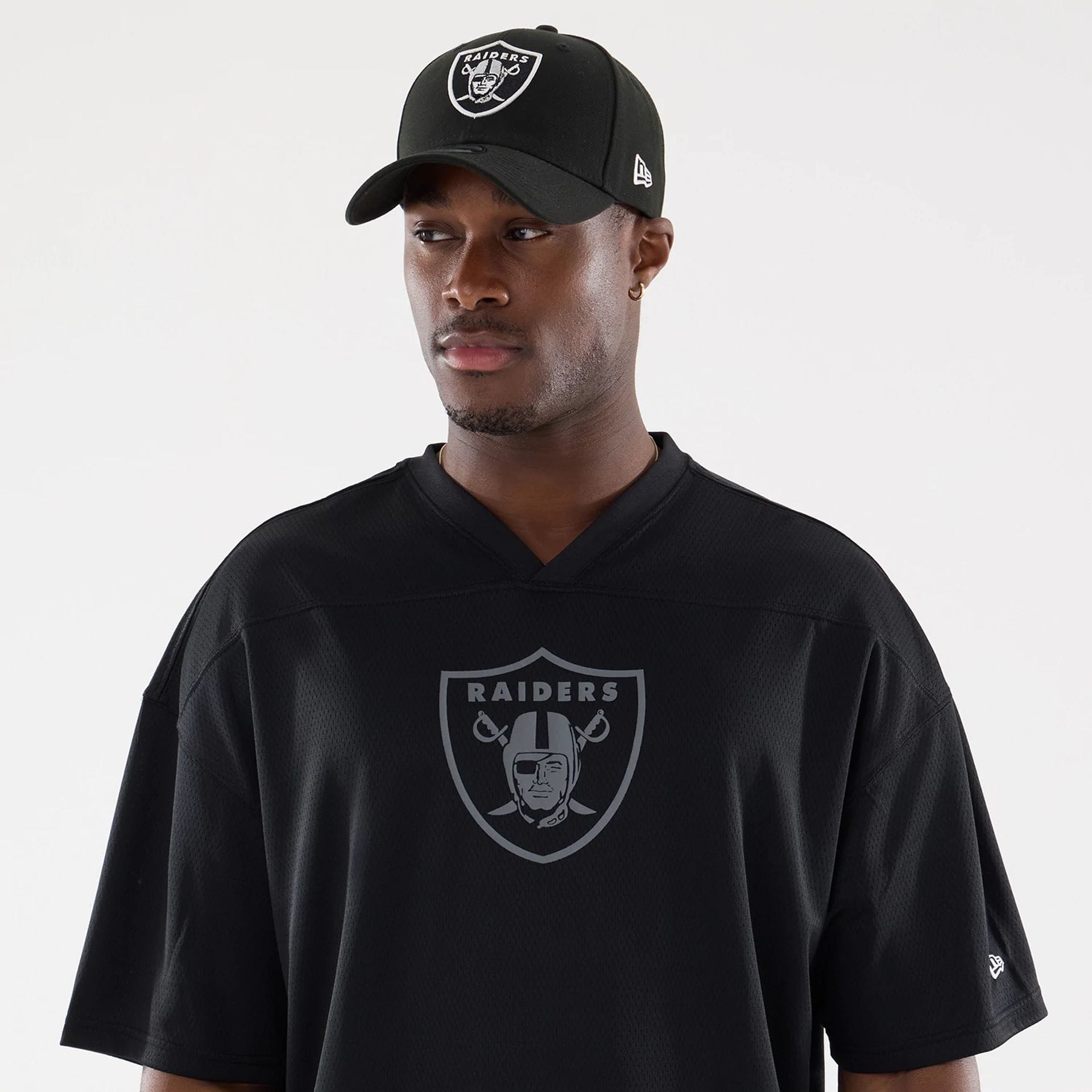 The model is wearing this NFL Raiders Wear Black Las Vegas Raiders Mesh Oversized T-Shirt in black. 6