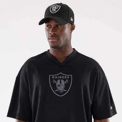 The model is wearing this NFL Raiders Wear Black Las Vegas Raiders Mesh Oversized T-Shirt in black. 6
