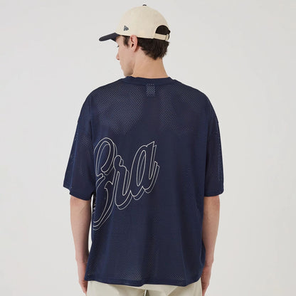 The model is wearing this New Era Mix League Oversized Mesh T-Shirt in blue. 2