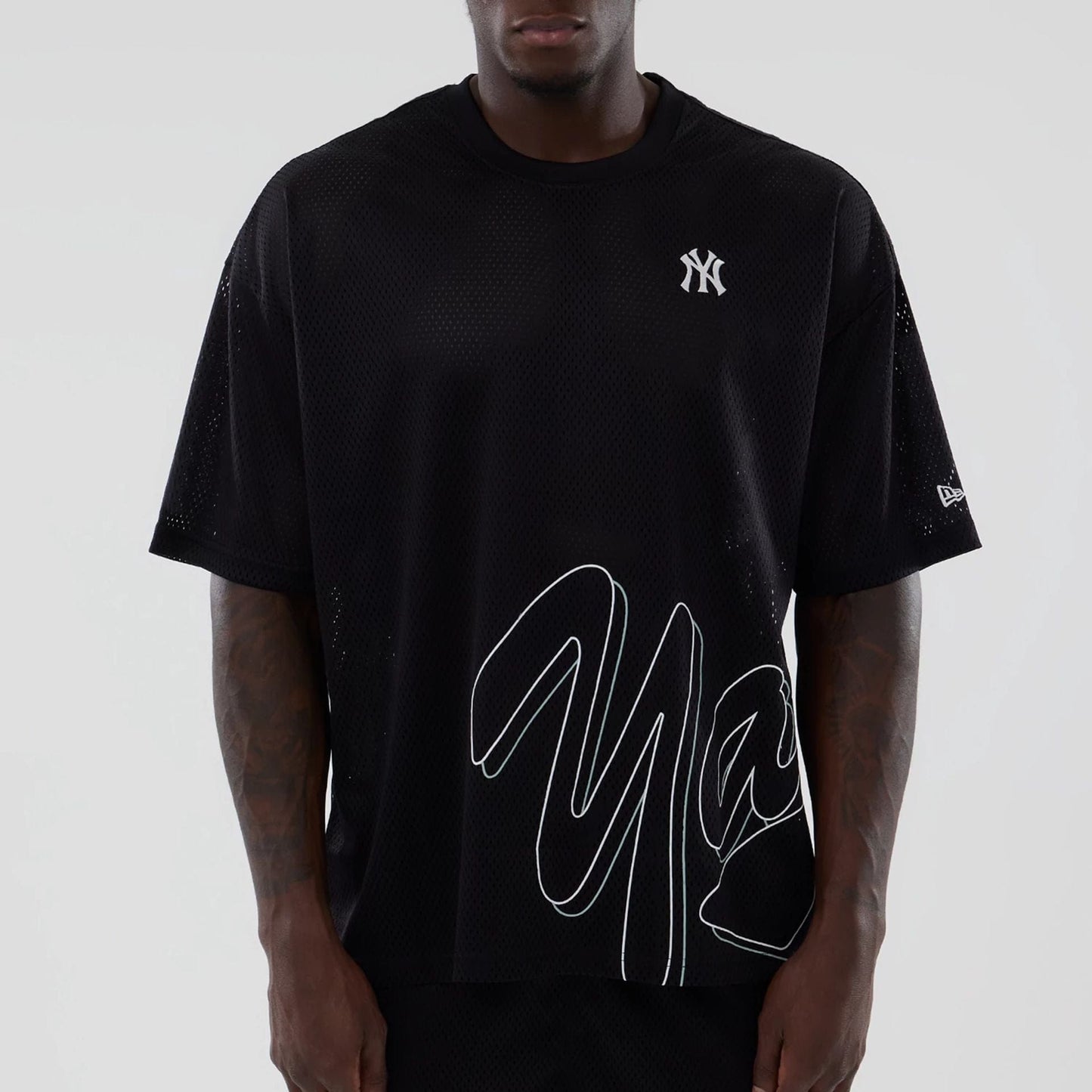 The model is wearing this MLB Mix League New York Yankees Oversized Mesh T-Shirt in black. 3