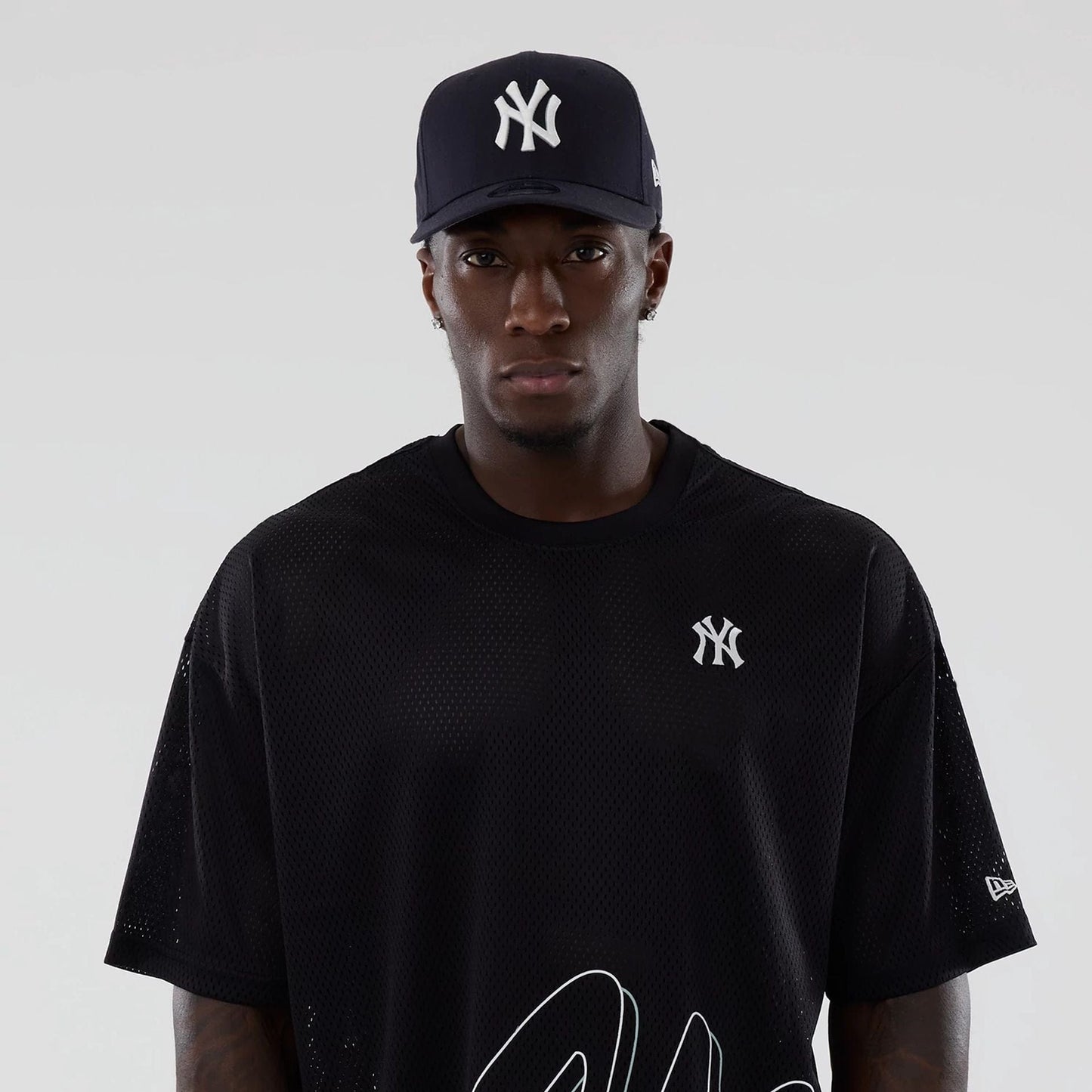 The model is wearing this MLB Mix League New York Yankees Oversized Mesh T-Shirt in black. 7