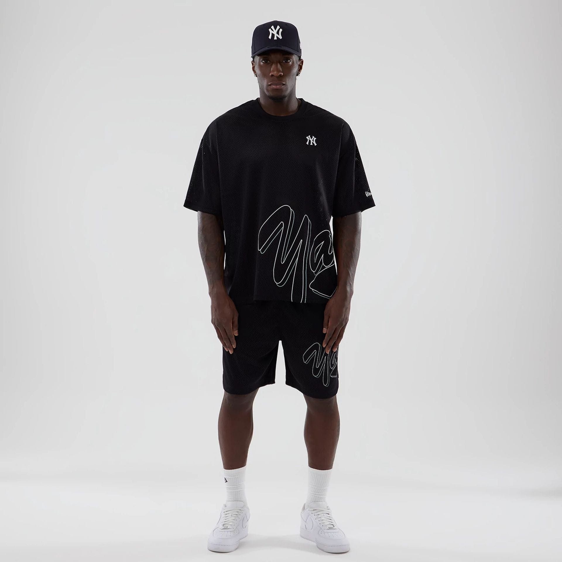 The model is wearing this MLB Mix League New York Yankees Oversized Mesh T-Shirt in black. 8