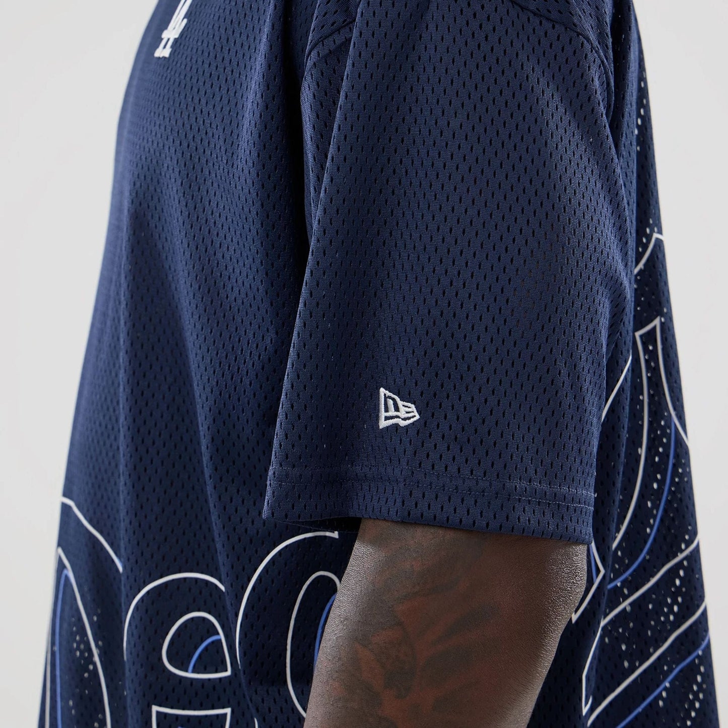 The model is wearing this MLB Mix League LA Dodgers Oversized Mesh T-Shirt in blue. 5