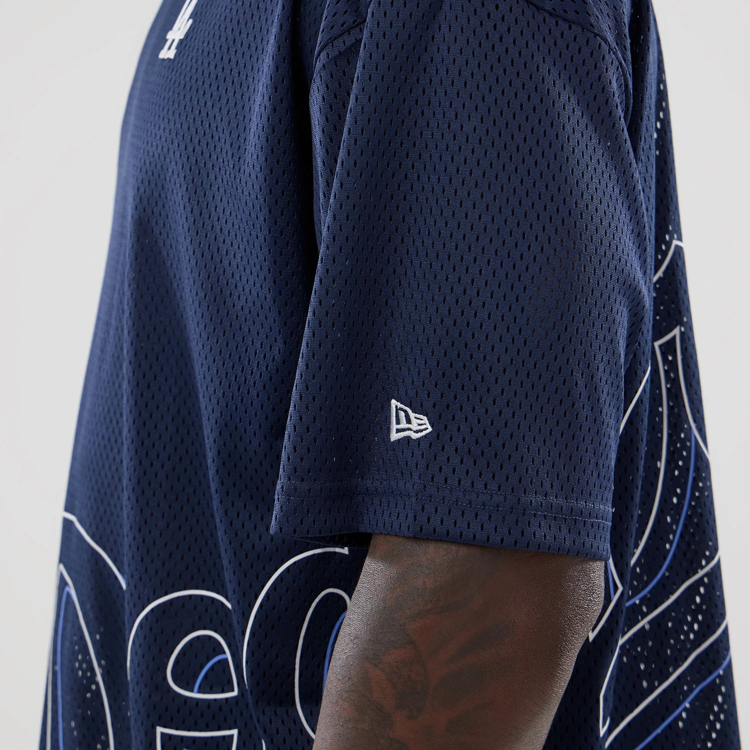 The model is wearing this MLB Mix League LA Dodgers Oversized Mesh T-Shirt in blue. 5