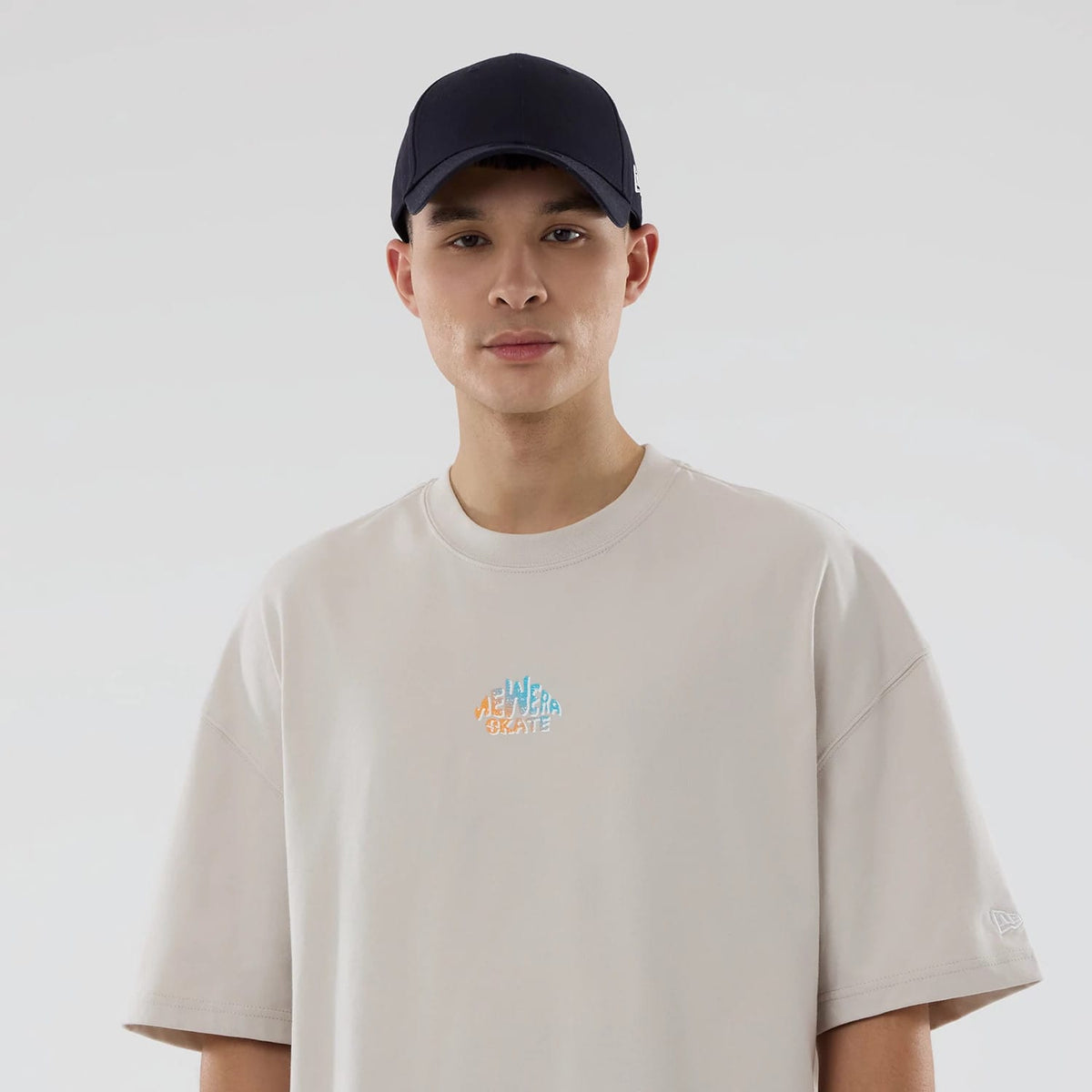 The model is wearing this New Era Skate Is Life Graphic Oversized T-Shirt in Cream. 6