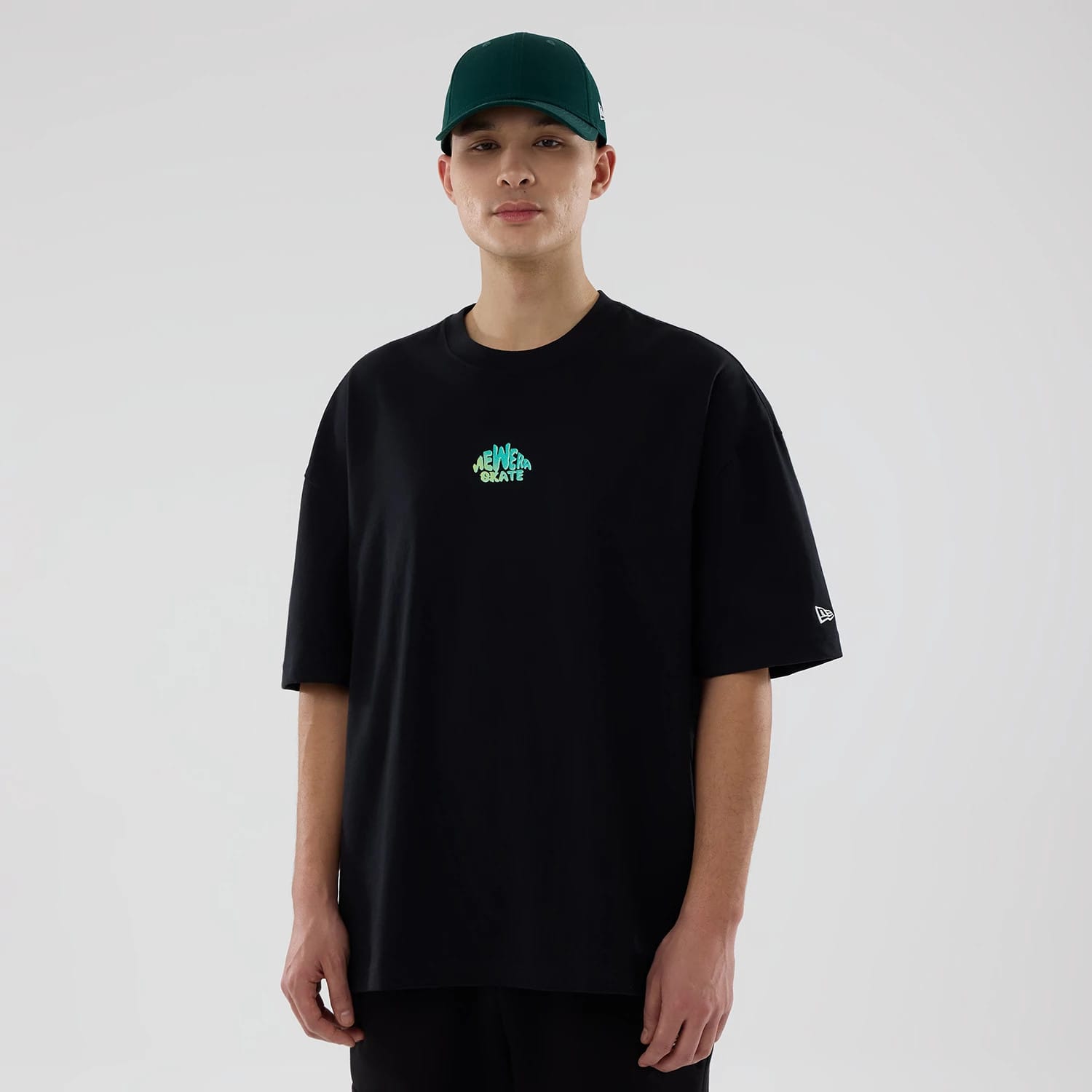 The model is wearing this New Era Skate Is Life Graphic Oversized T-Shirt in black. 1