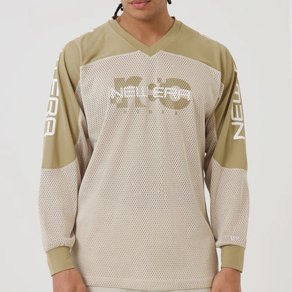 The model is wearing this New Era NEC Logo Long Sleeve Jersey in beige/khaki. 3