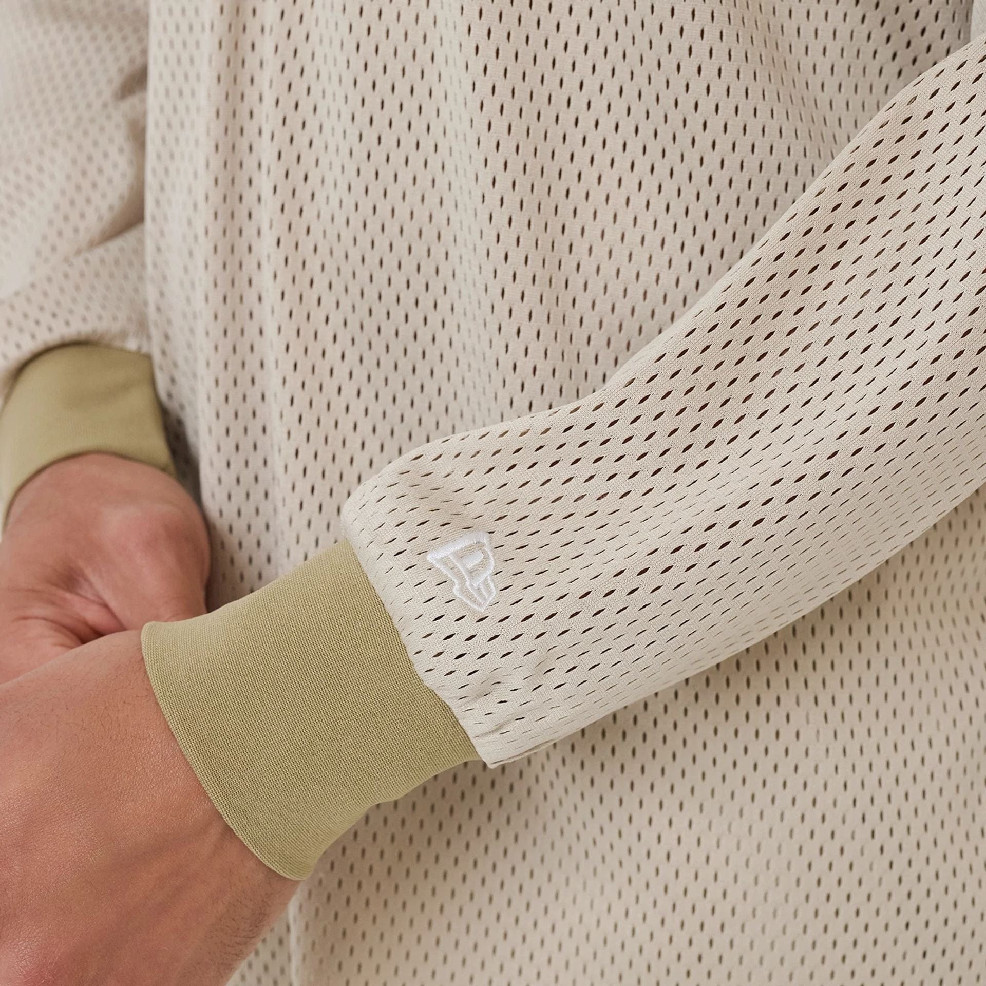 The model is wearing this New Era NEC Logo Long Sleeve Jersey in beige/khaki. 6
