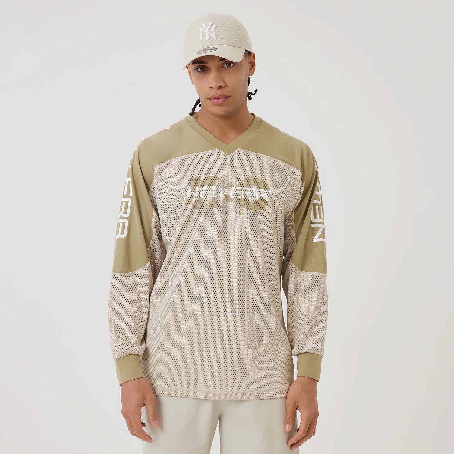 The model is wearing this New Era NEC Logo Long Sleeve Jersey in beige/khaki. 1