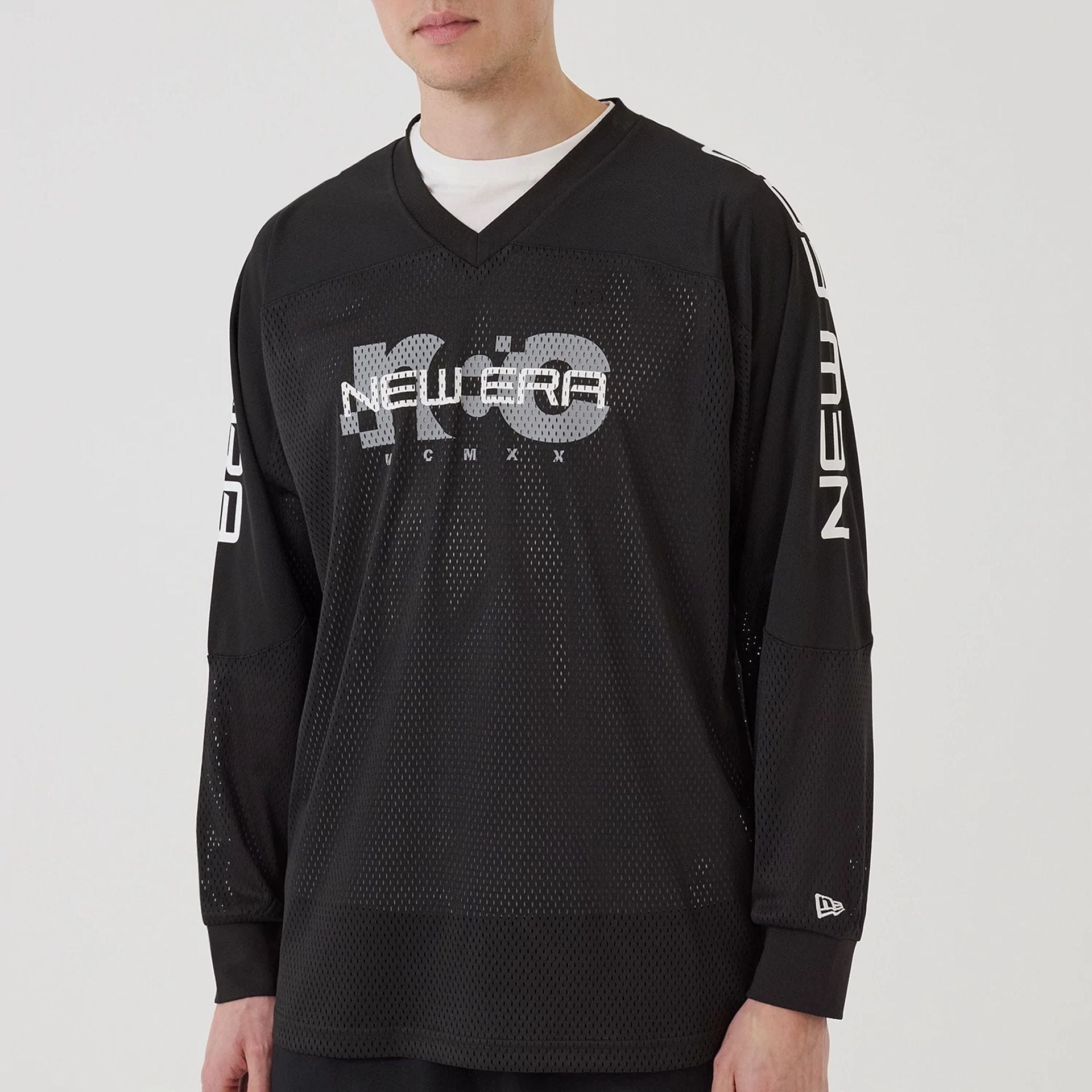The model is wearing this New Era NEC Logo Long Sleeve Jersey in black. 6