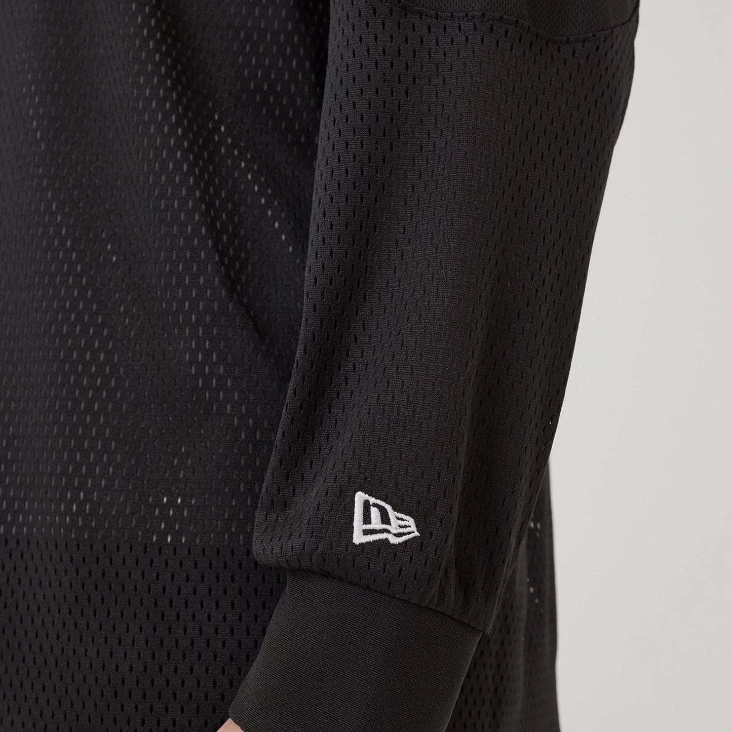 The model is wearing this New Era NEC Logo Long Sleeve Jersey in black. 5