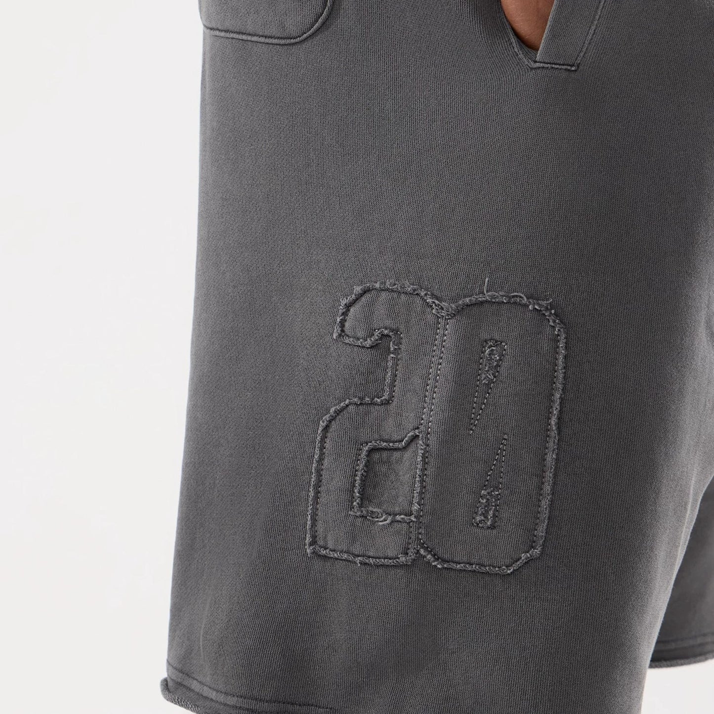 The model is wearing this New Era Street Archived Oversized Shorts in black. 4