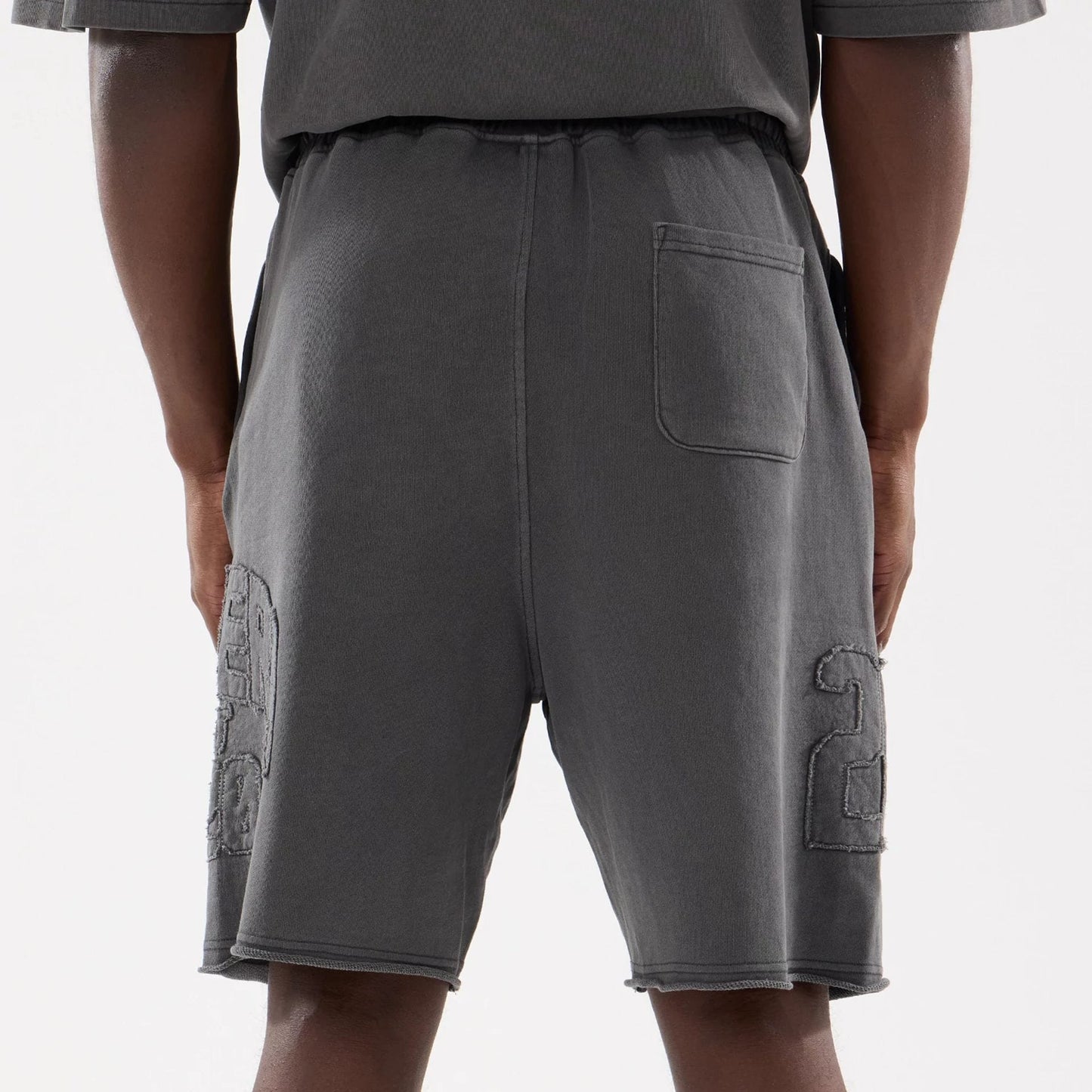 The model is wearing this New Era Street Archived Oversized Shorts in black. 7