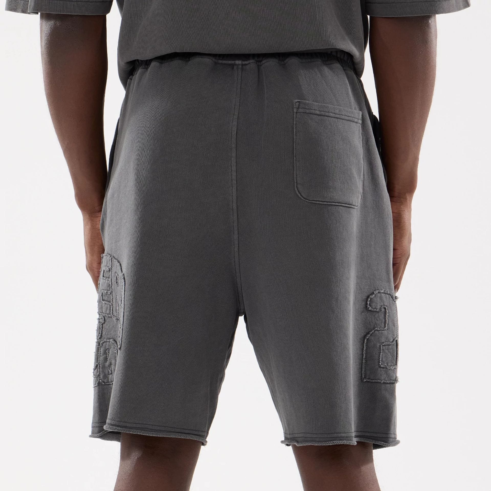 The model is wearing this New Era Street Archived Oversized Shorts in black. 7