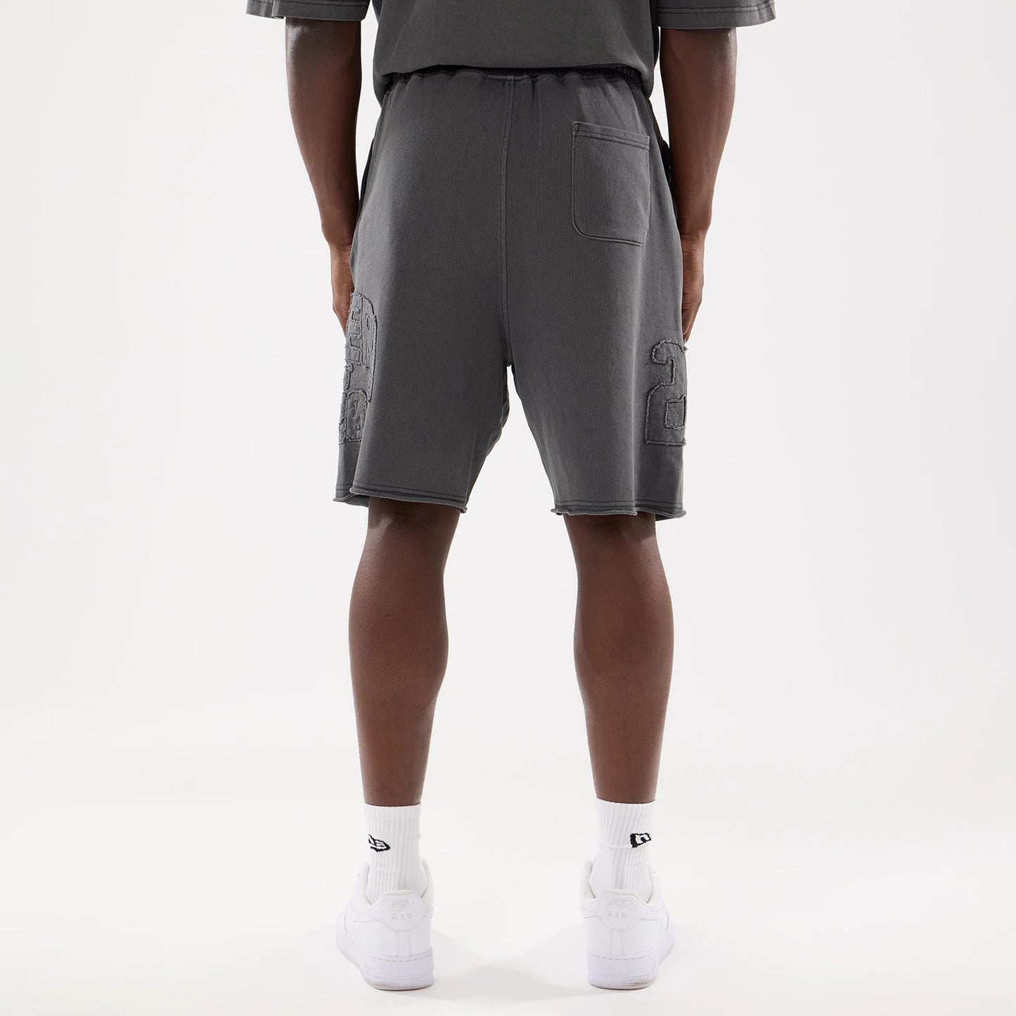 The model is wearing this New Era Street Archived Oversized Shorts in black. 2