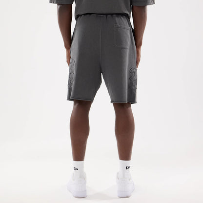 The model is wearing this New Era Street Archived Oversized Shorts in black. 2