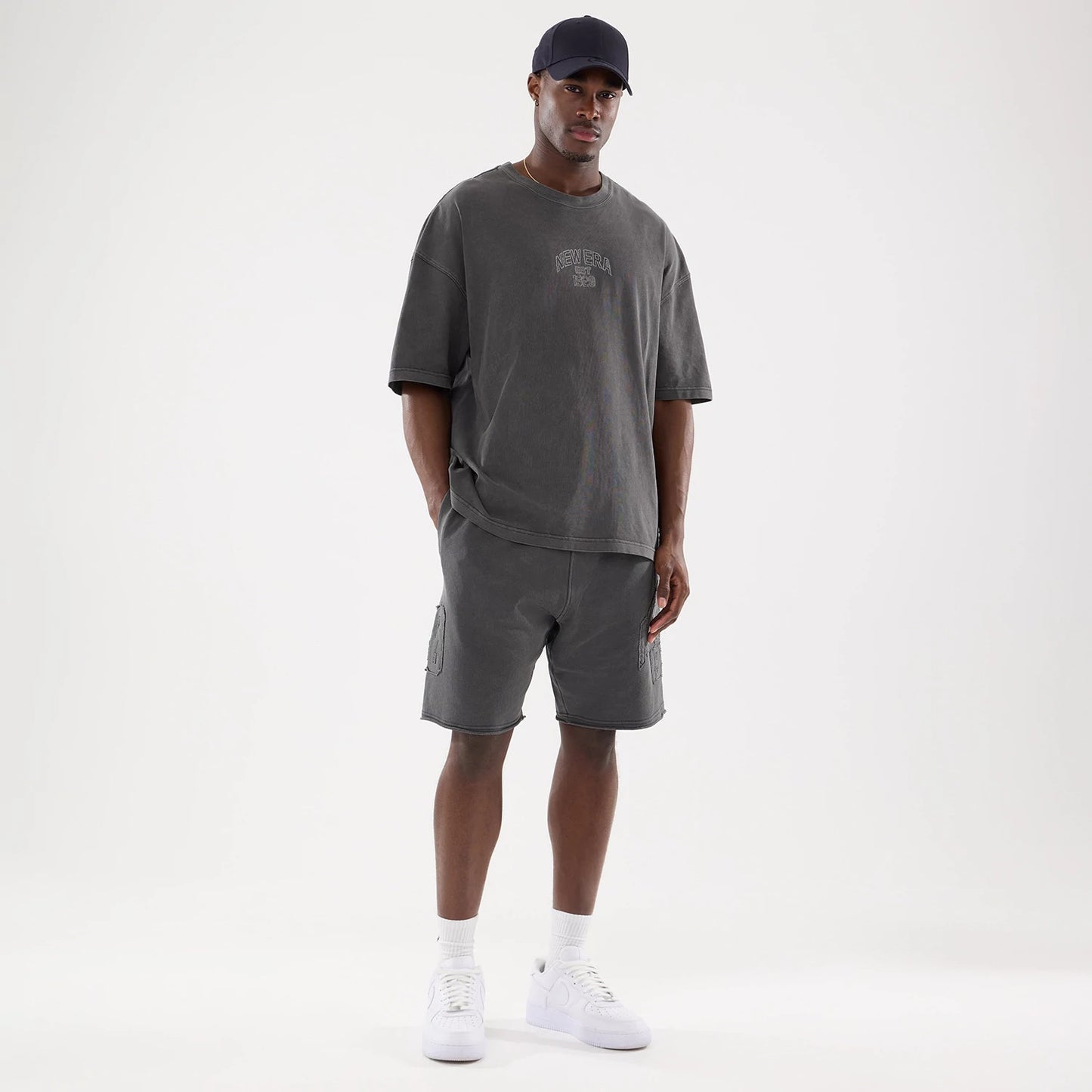 The model is wearing this New Era Street Archived Oversized Shorts in black. 8