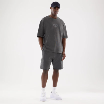 The model is wearing this New Era Street Archived Oversized Shorts in black. 8