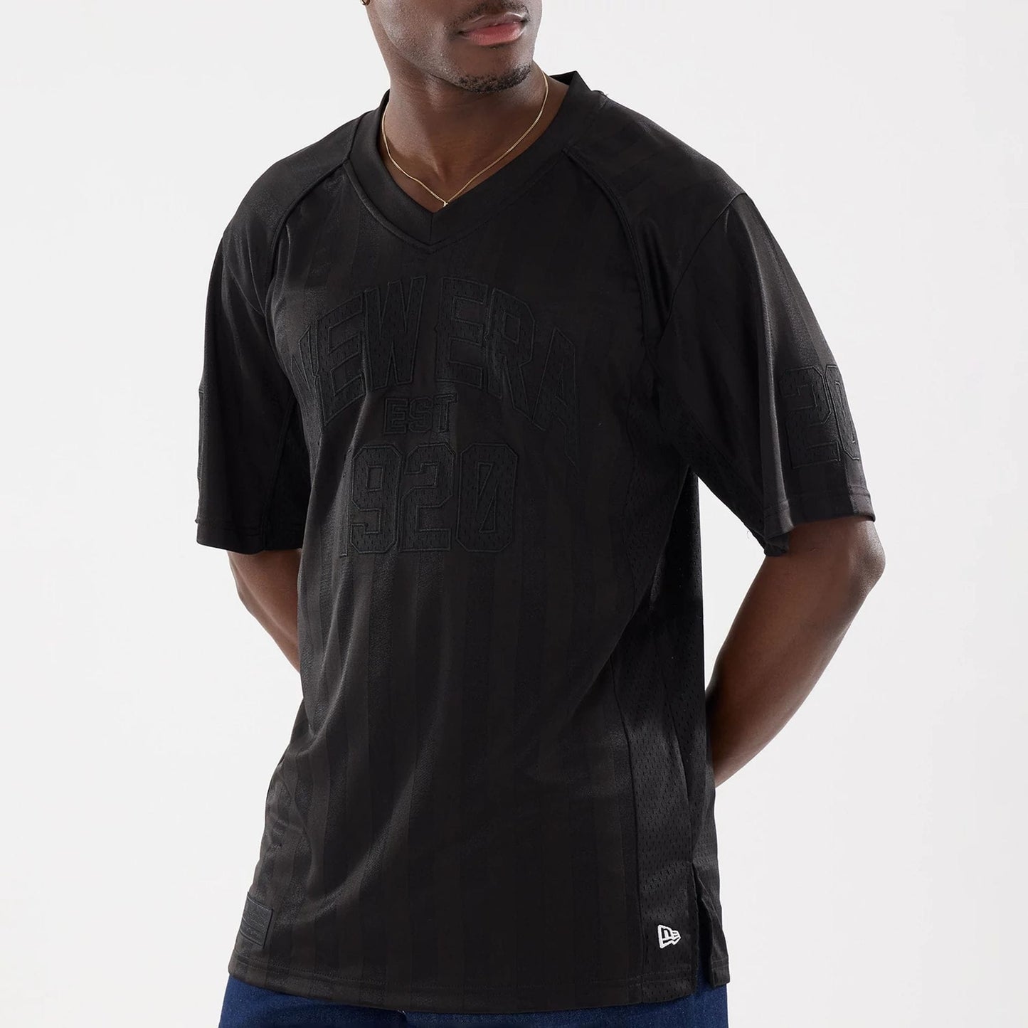 The model is wearing this New Era Street Archived Mesh Jersey in black. 3
