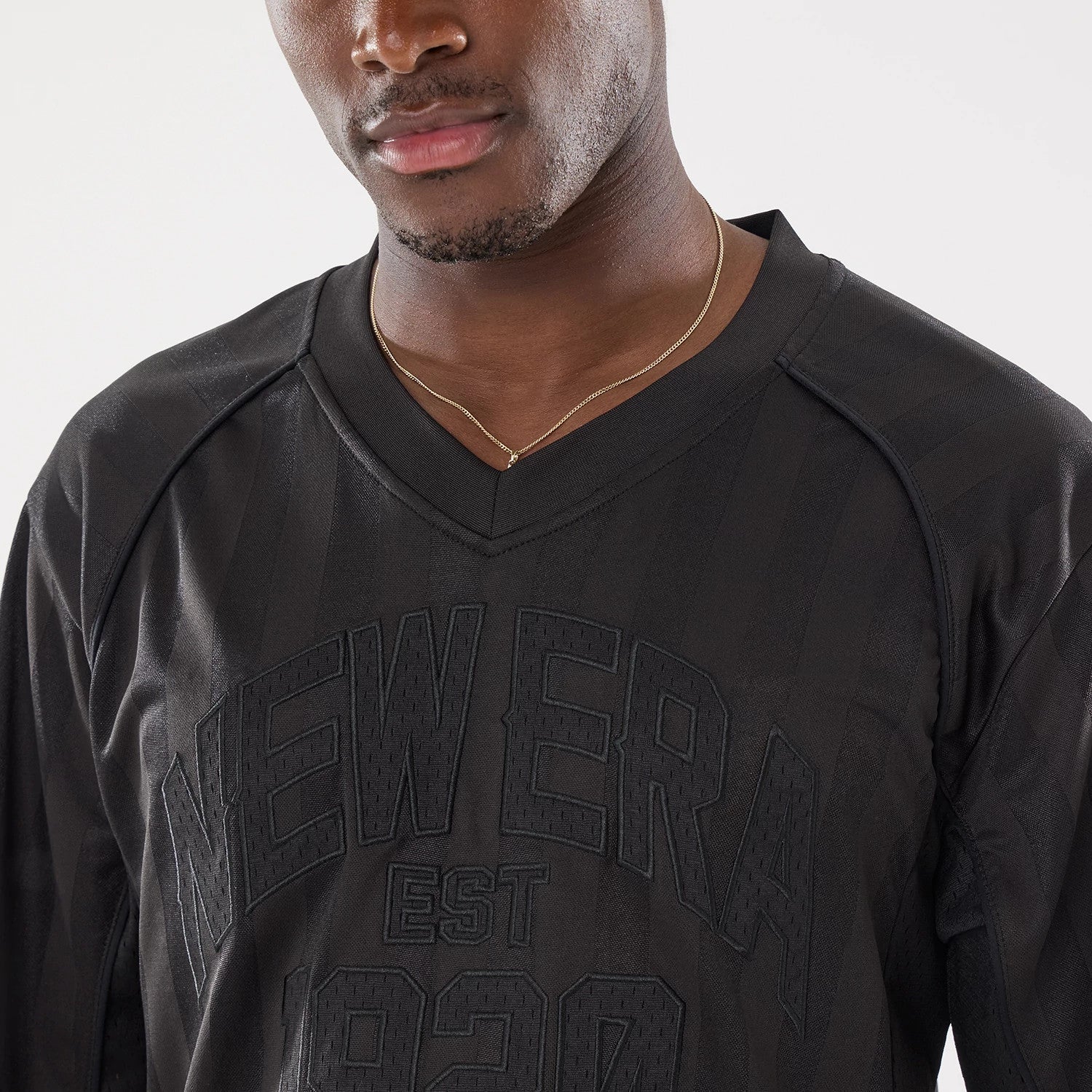 The model is wearing this New Era Street Archived Mesh Jersey in black. 4