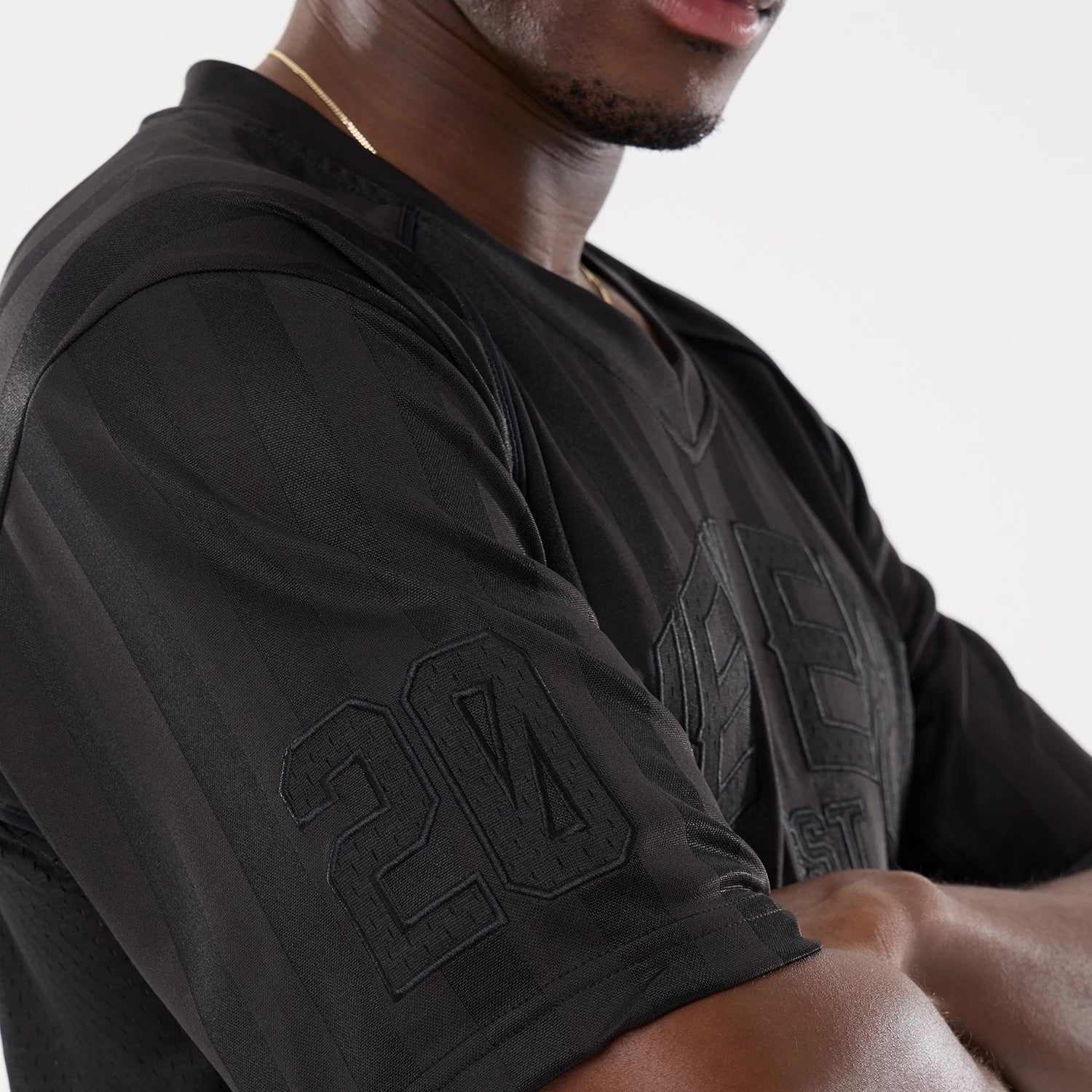 The model is wearing this New Era Street Archived Mesh Jersey in black. 6