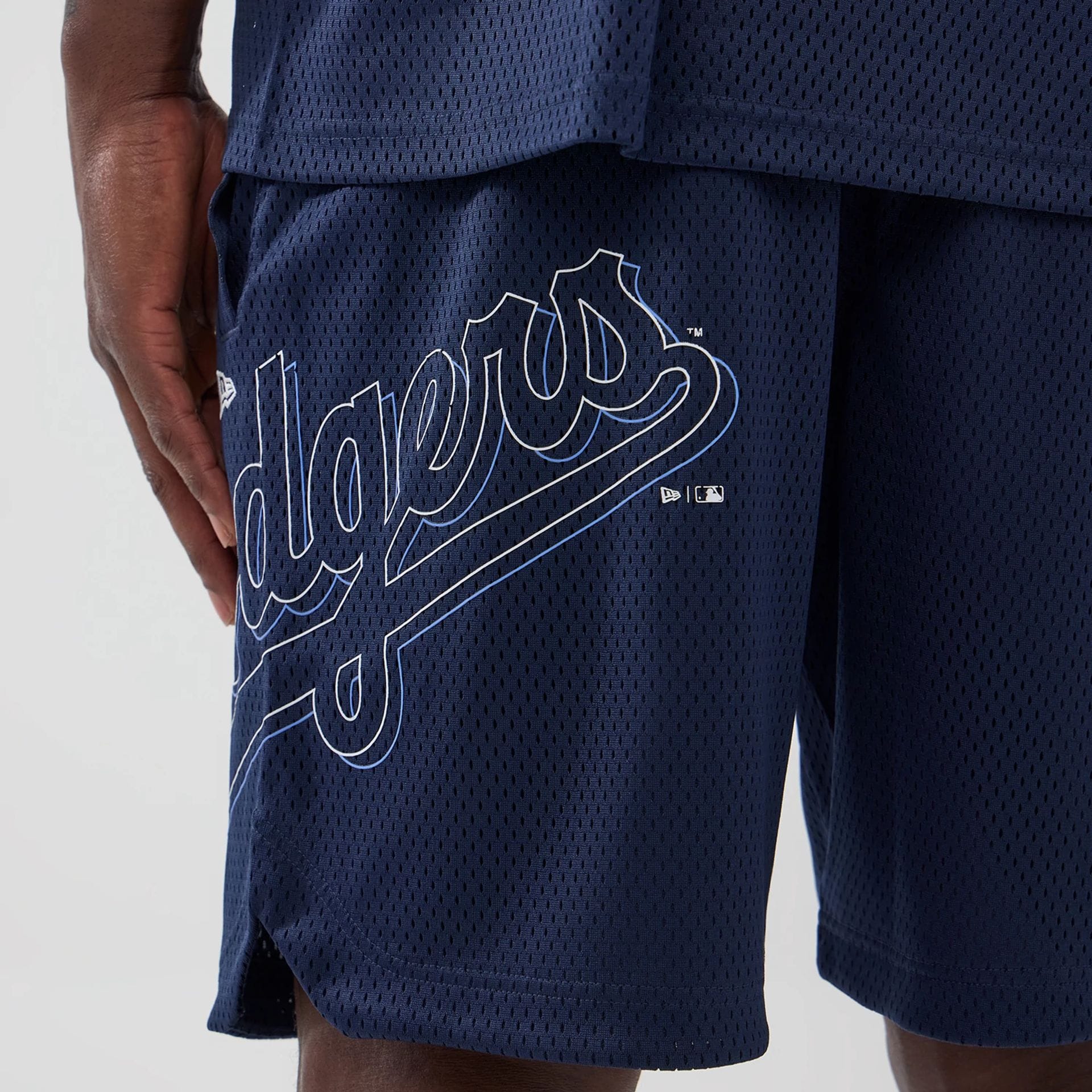 The model is wearing this MLB Mix League LA Dodgers Oversized Mesh Shorts in blue. 2