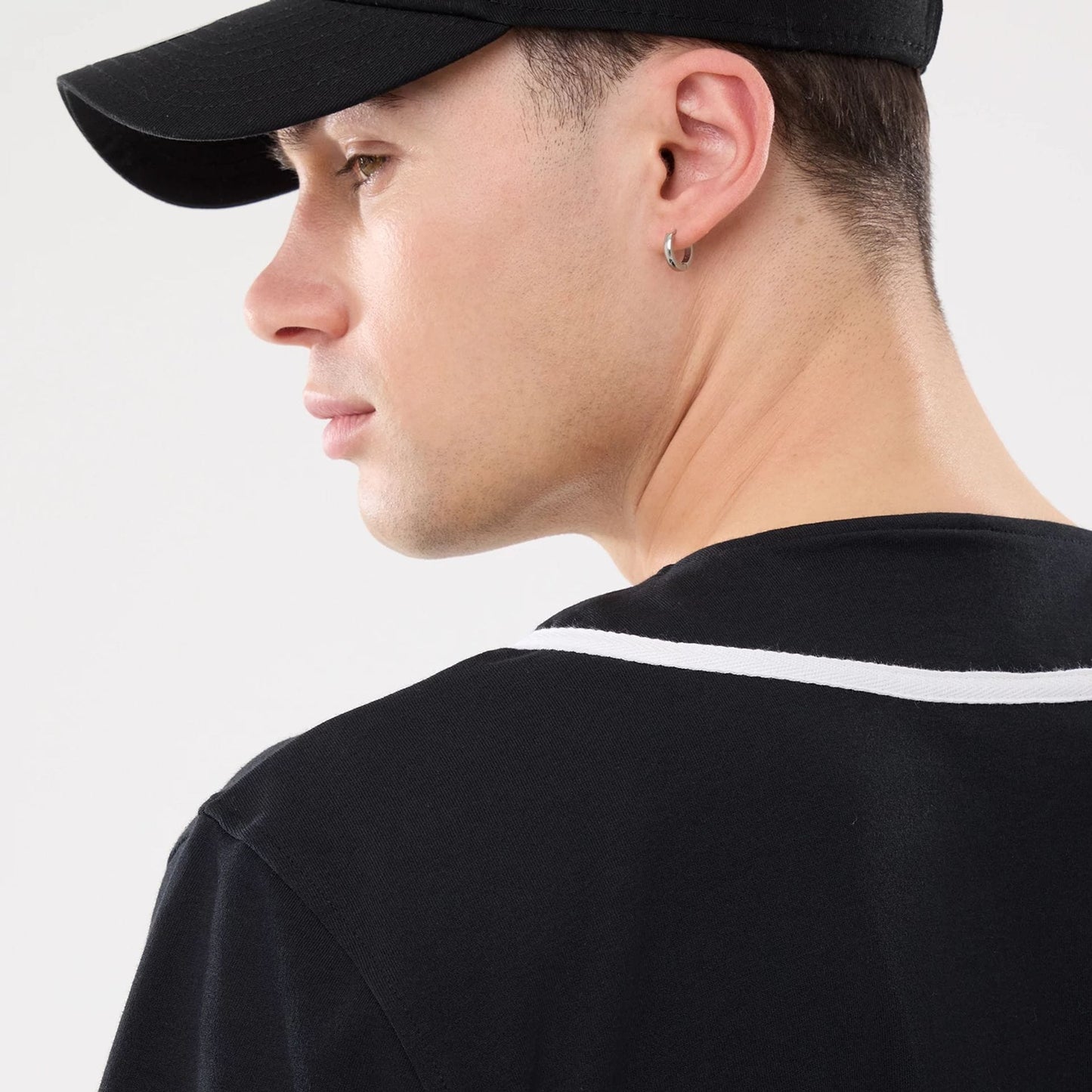 The model is wearing this New Era Basic Jersey in black. 6