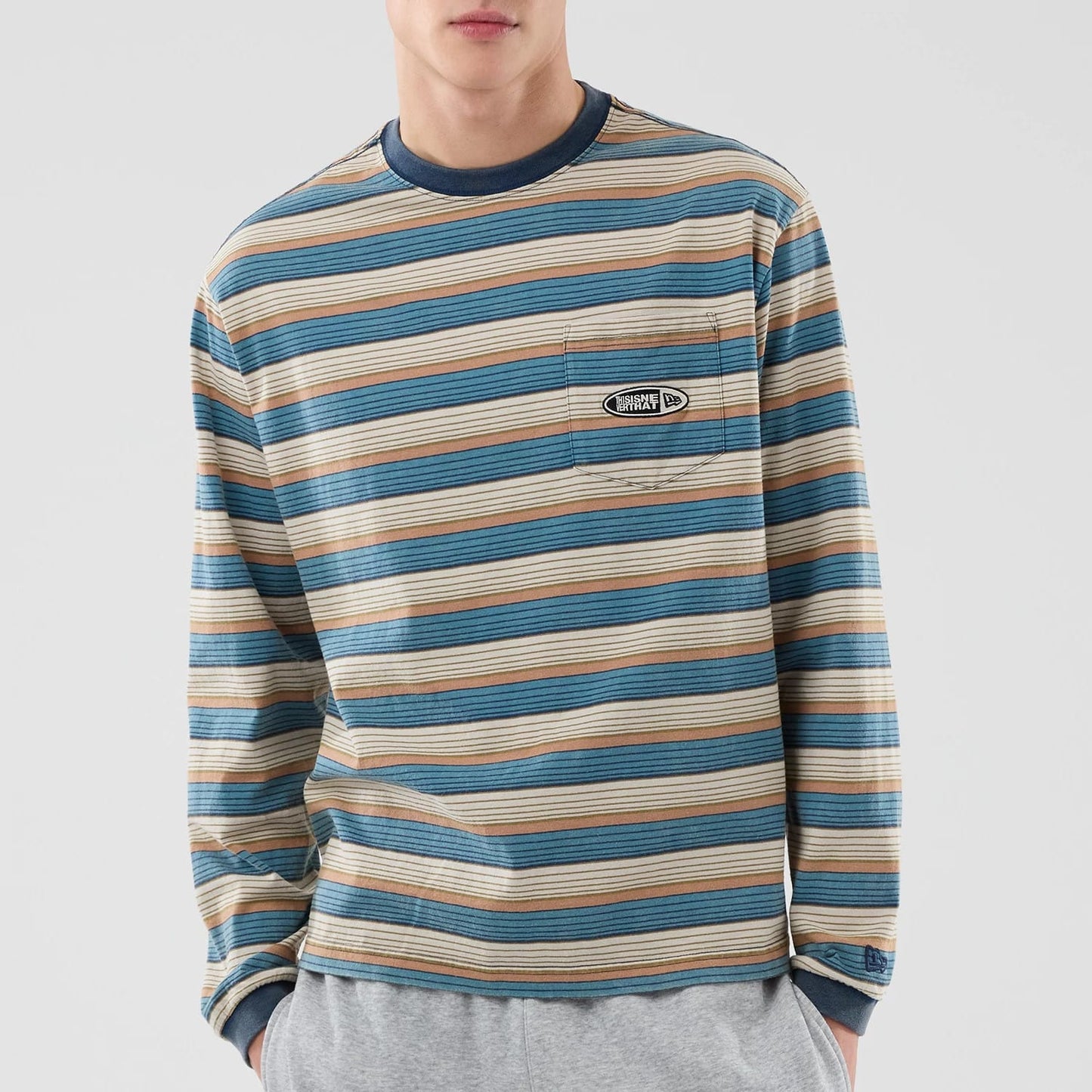 The model is wearing this Thisisneverthat X New Era Border Long Sleeve T-Shirt in beige. 5