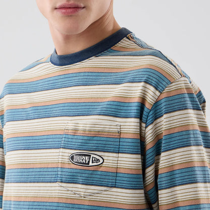 The model is wearing this Thisisneverthat X New Era Border Long Sleeve T-Shirt in beige. 3