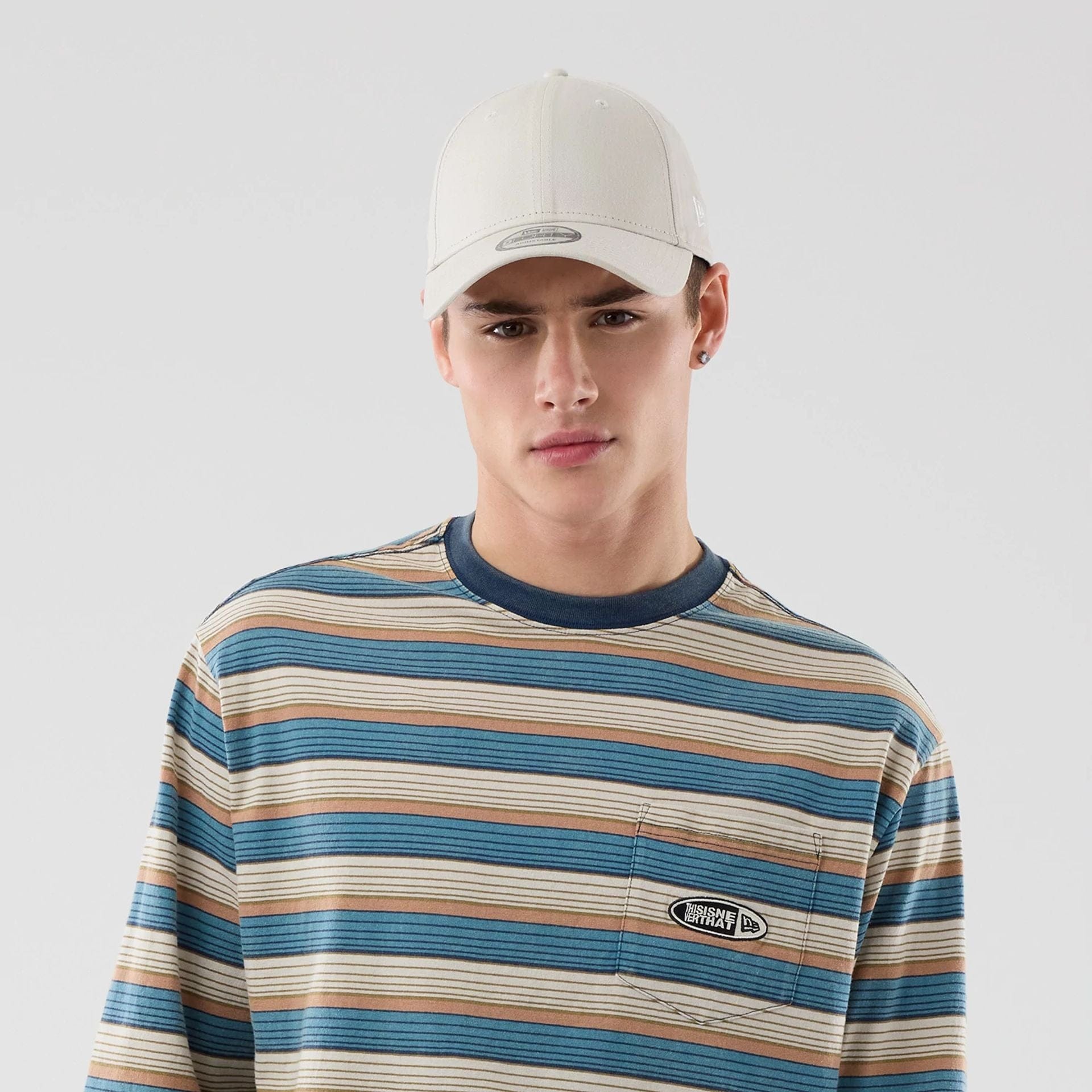 The model is wearing this Thisisneverthat X New Era Border Long Sleeve T-Shirt in beige. 6