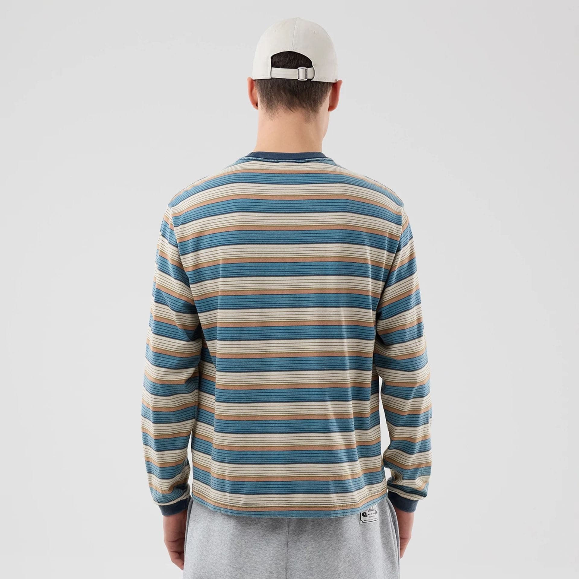 The model is wearing this Thisisneverthat X New Era Border Long Sleeve T-Shirt in beige. 2