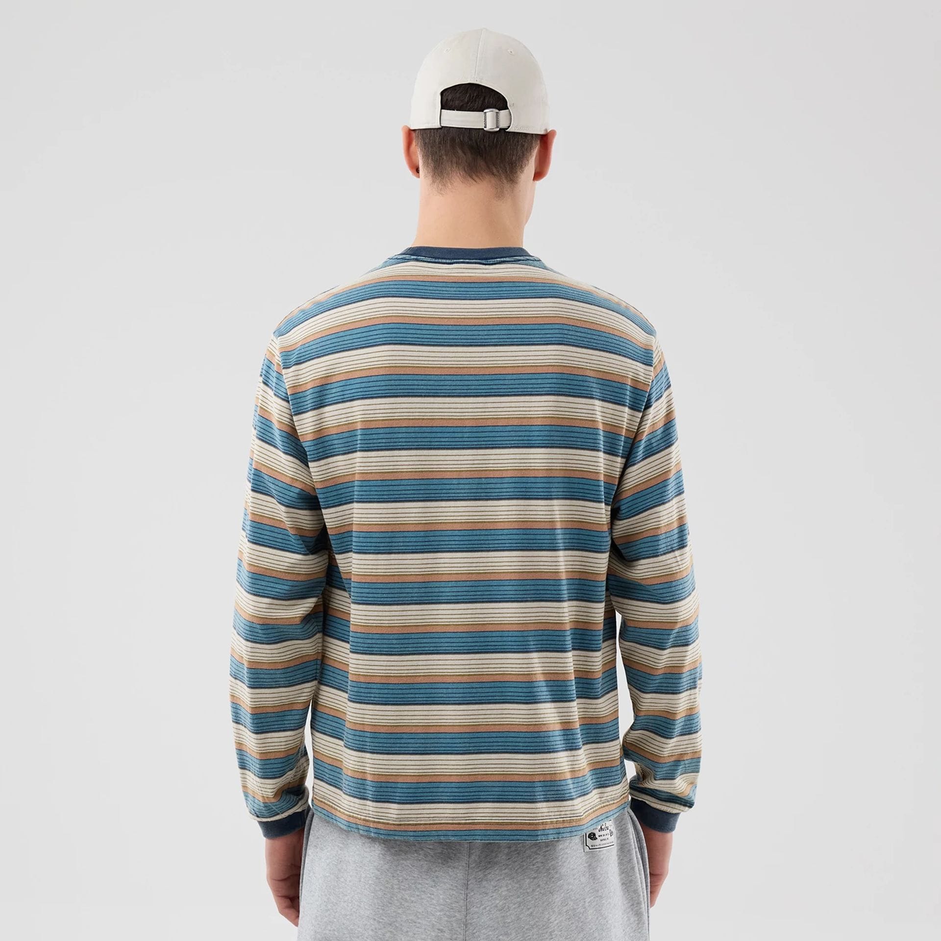 The model is wearing this Thisisneverthat X New Era Border Long Sleeve T-Shirt in beige. 2